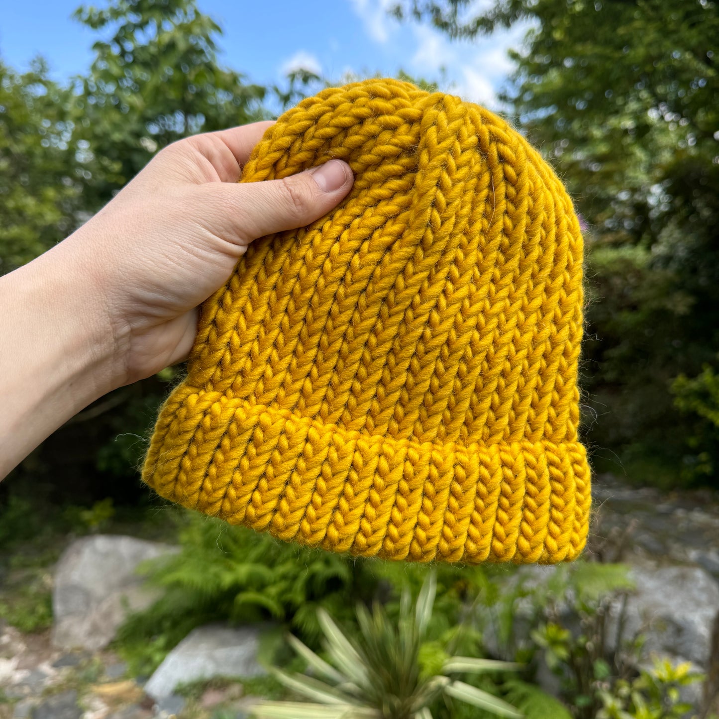 Colourful modern knitted hat in mustard yellow made from 100% merino wool