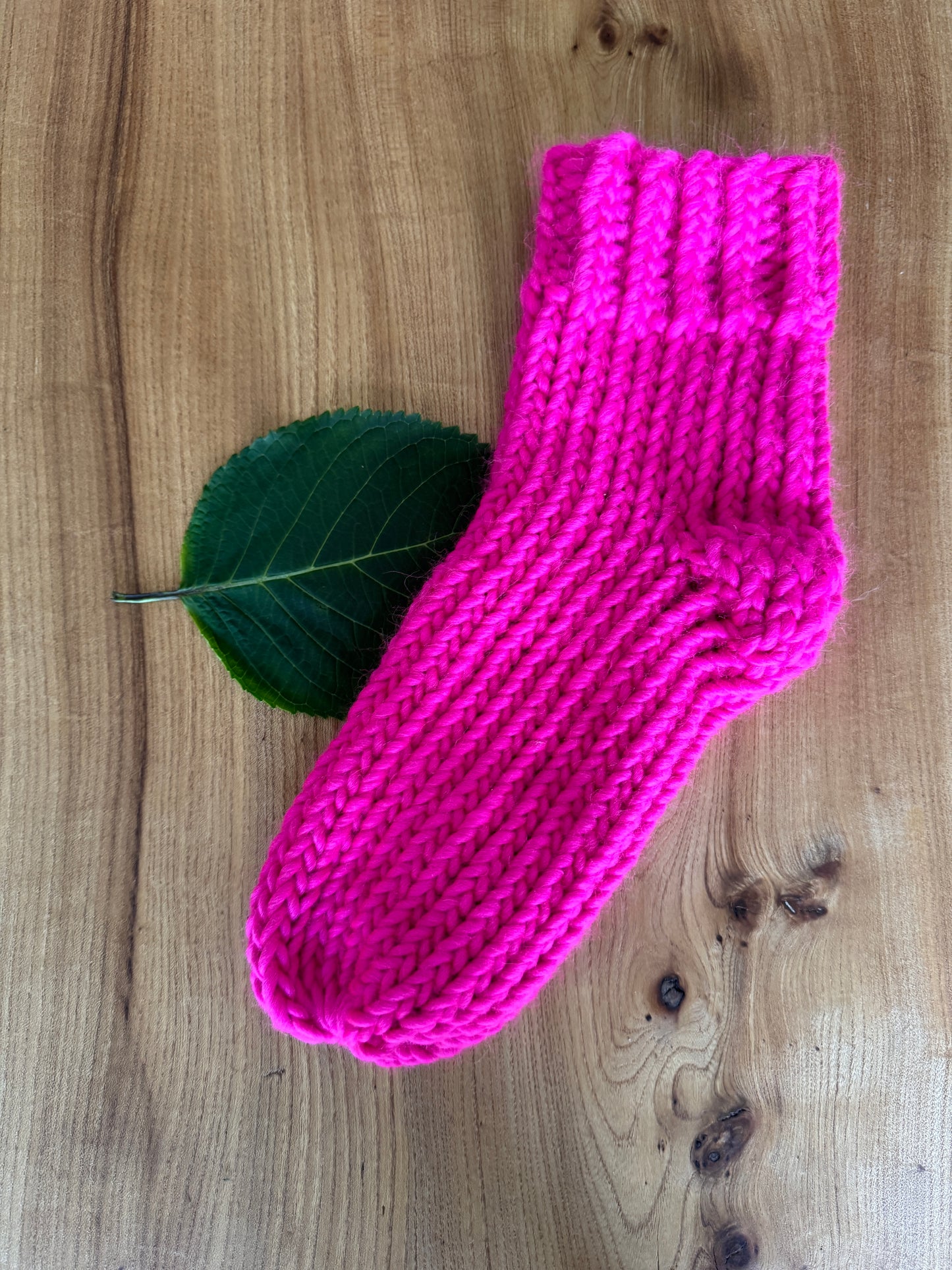 Hand Knitted 100% merino wool socks in bright neon pink by The Dorothy Days knitwear company