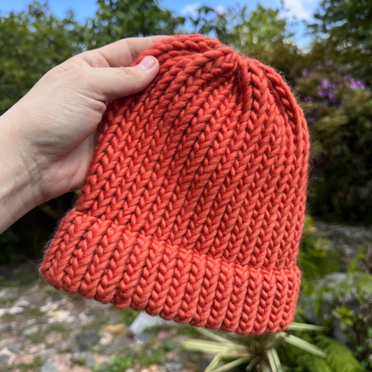 Hand knitted burnt orange beanie hat made from 100% merino wool. This hat has been hand knitted in the Tamar Valley in Cornwall with colours inspired by nature