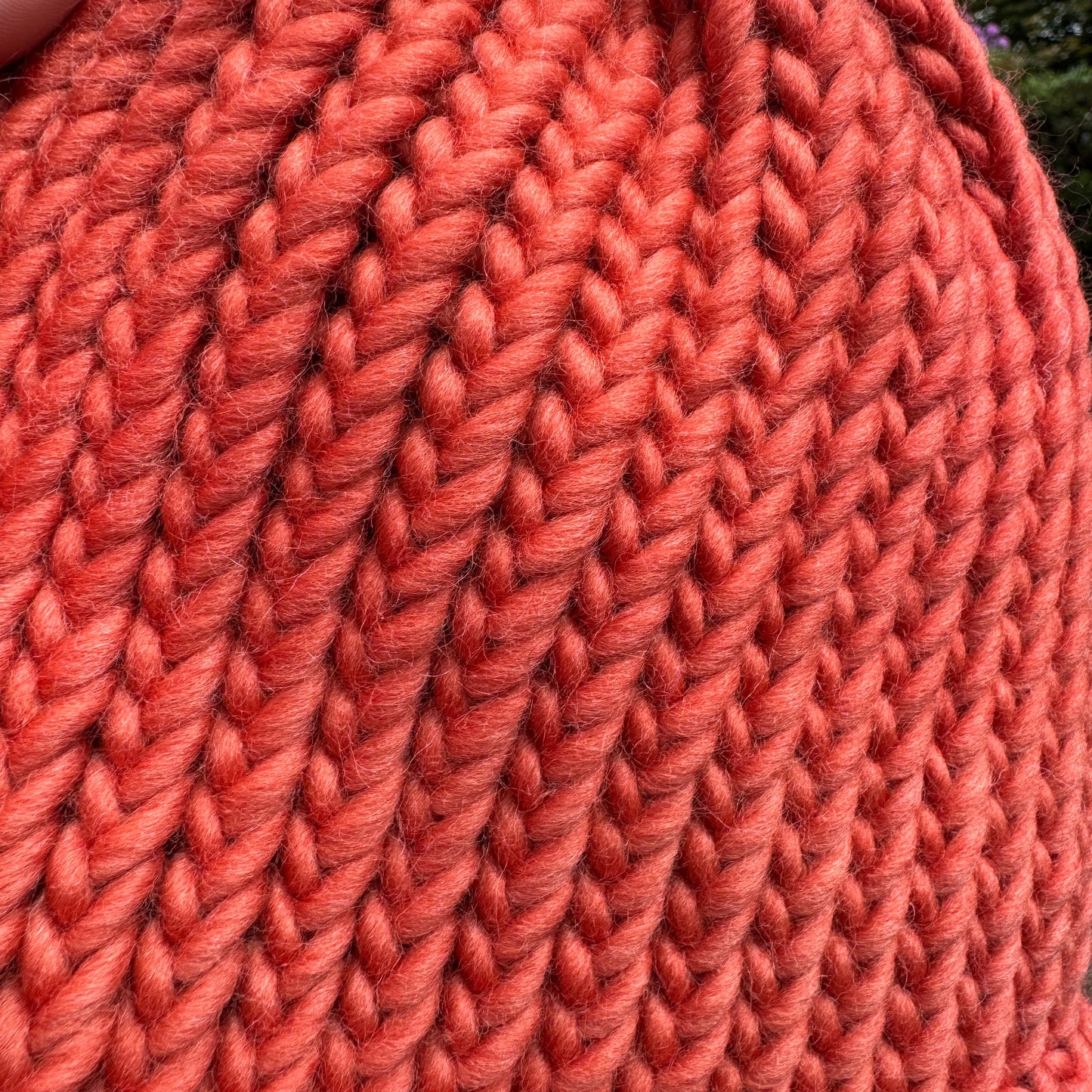 Close up photograph of chunky knit stitches of our burnt orange bobble hat