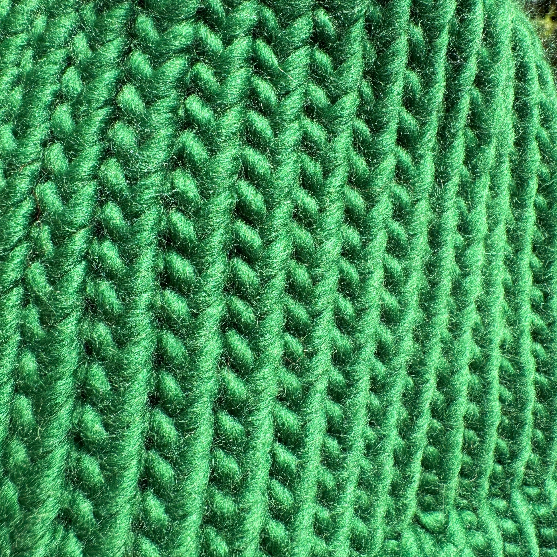 Close up of knitted stitches for the hand knitted pine green hat showing the chunky knit style of this beanie
