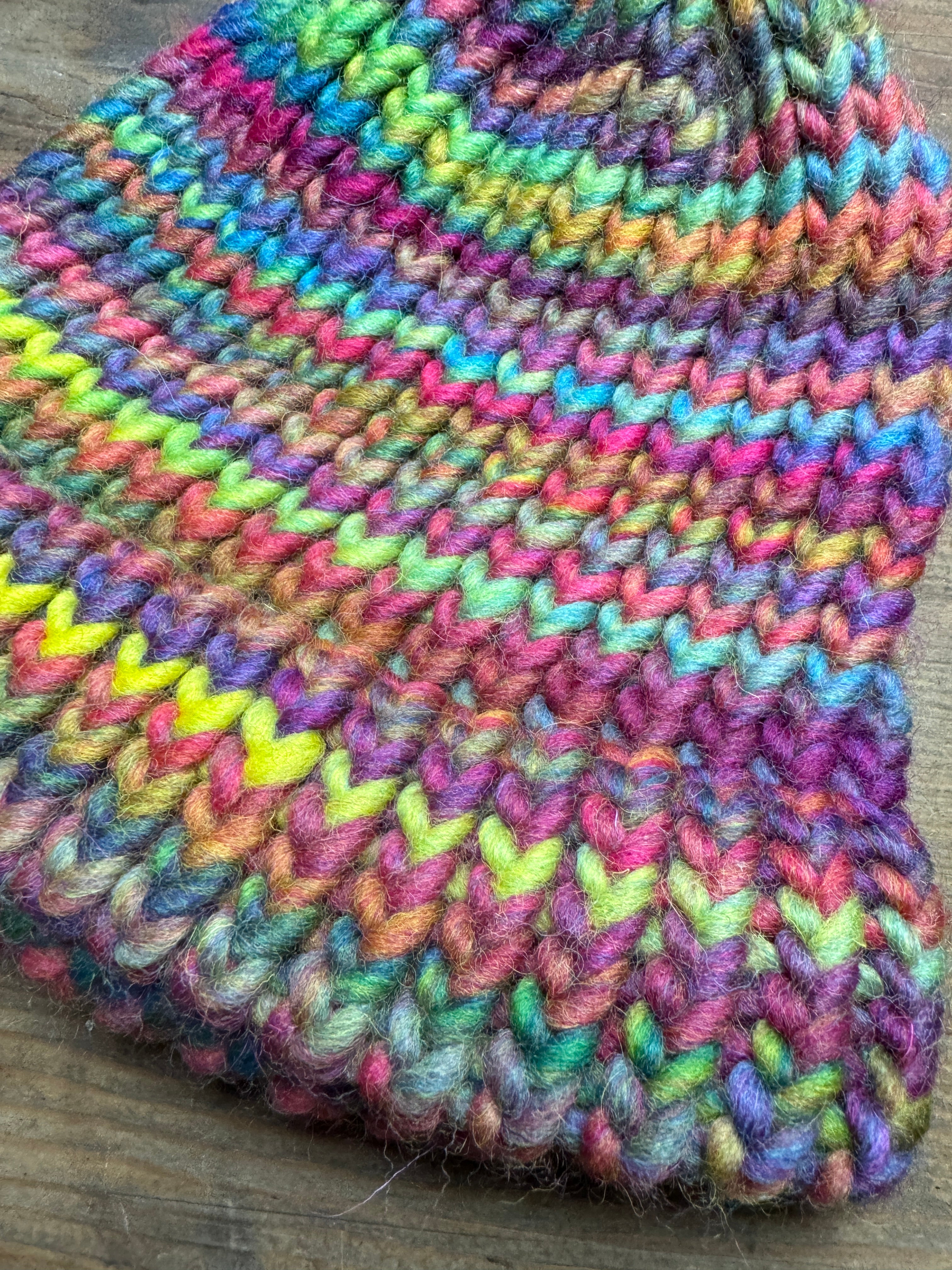 Adult knitted rainbow hat with pom pom