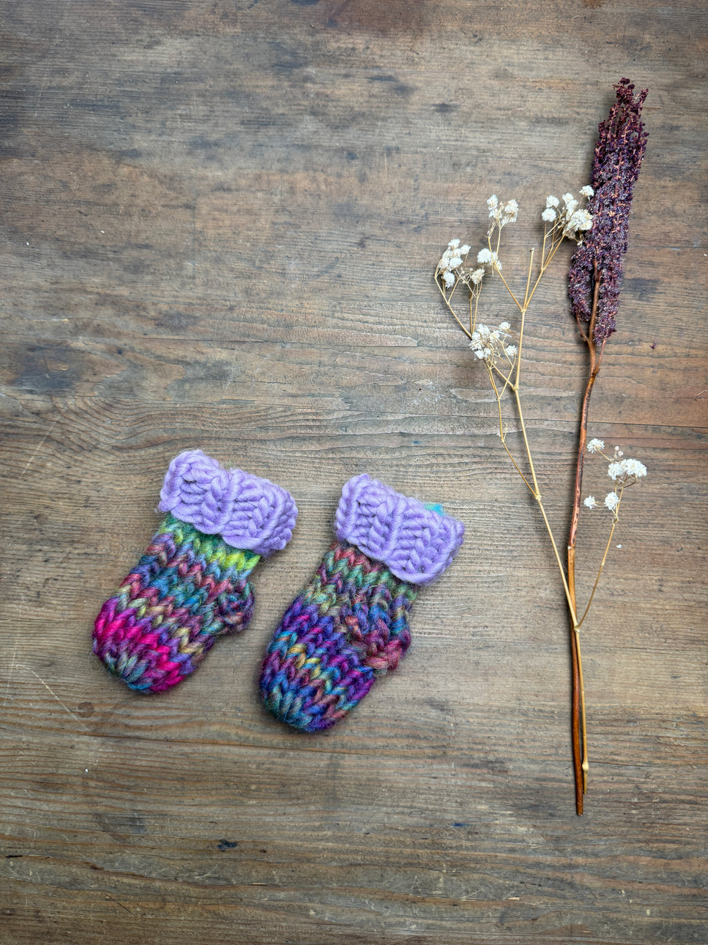 Newborn knitted socks in lilac and rainbow
