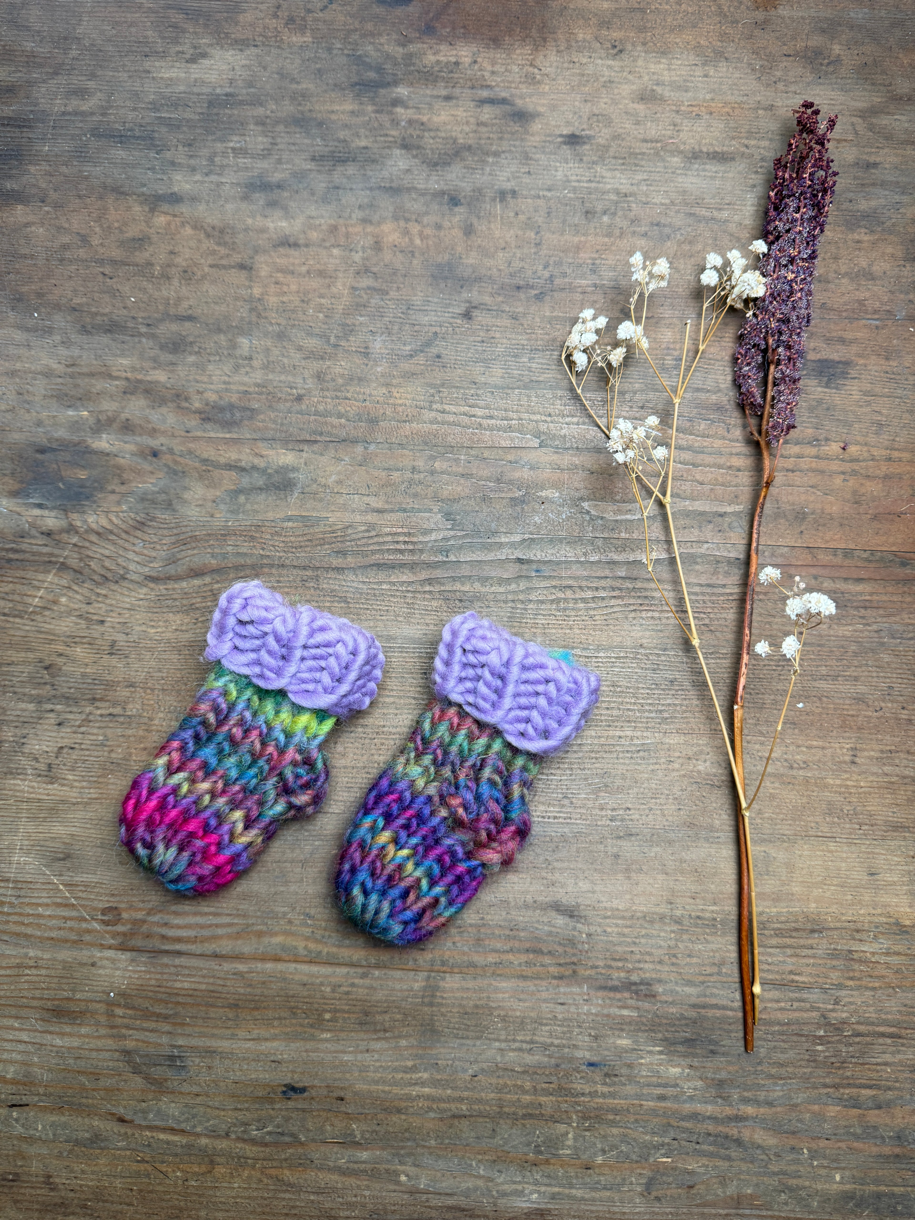 Newborn knitted socks in lilac and rainbow