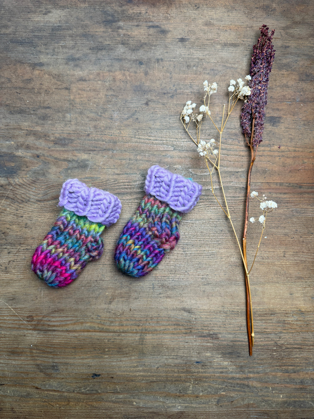 Newborn knitted socks in lilac and rainbow