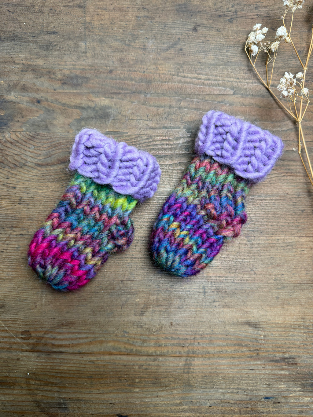 Newborn knitted socks in lilac and rainbow