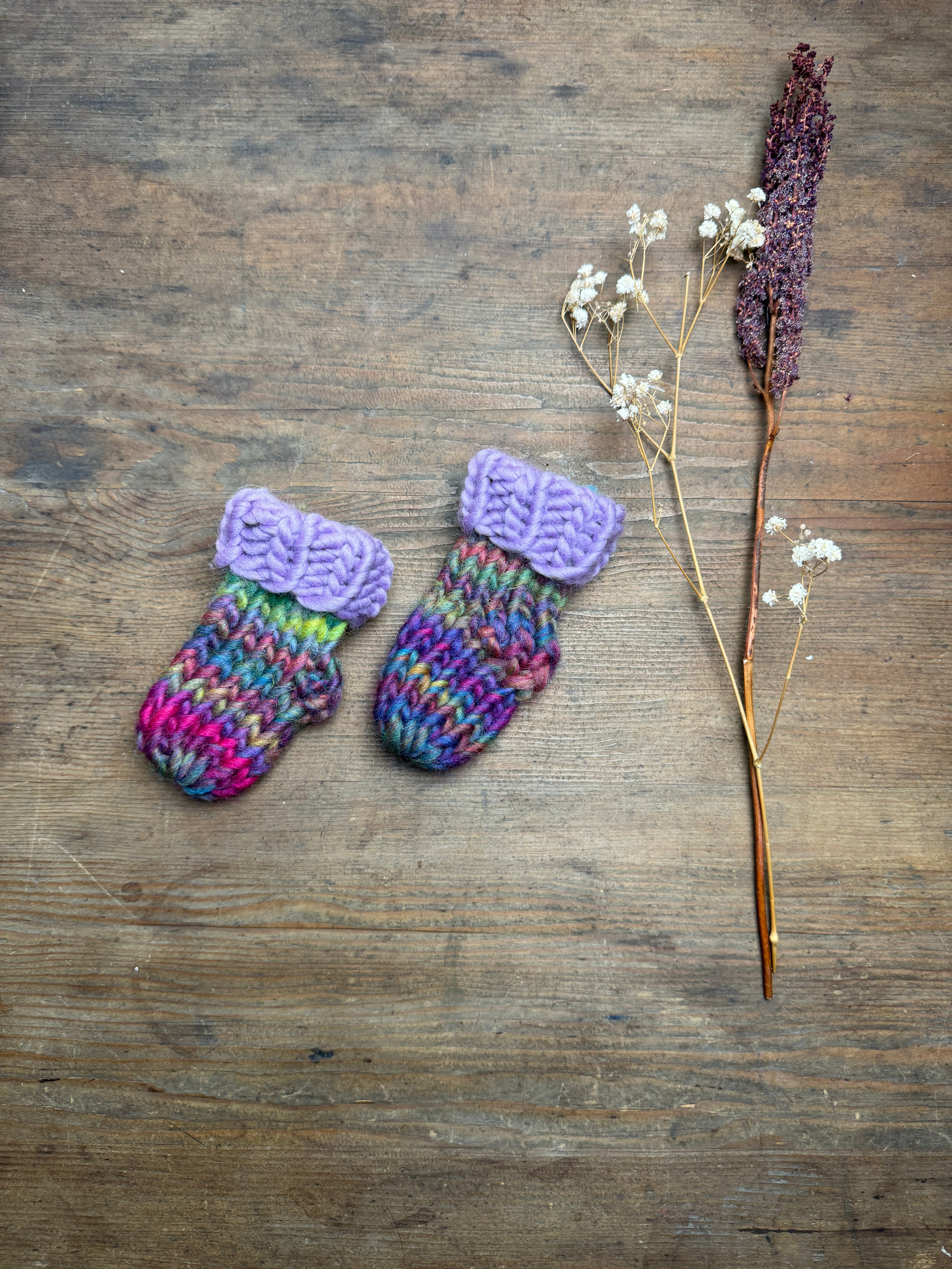 Newborn knitted socks in lilac and rainbow