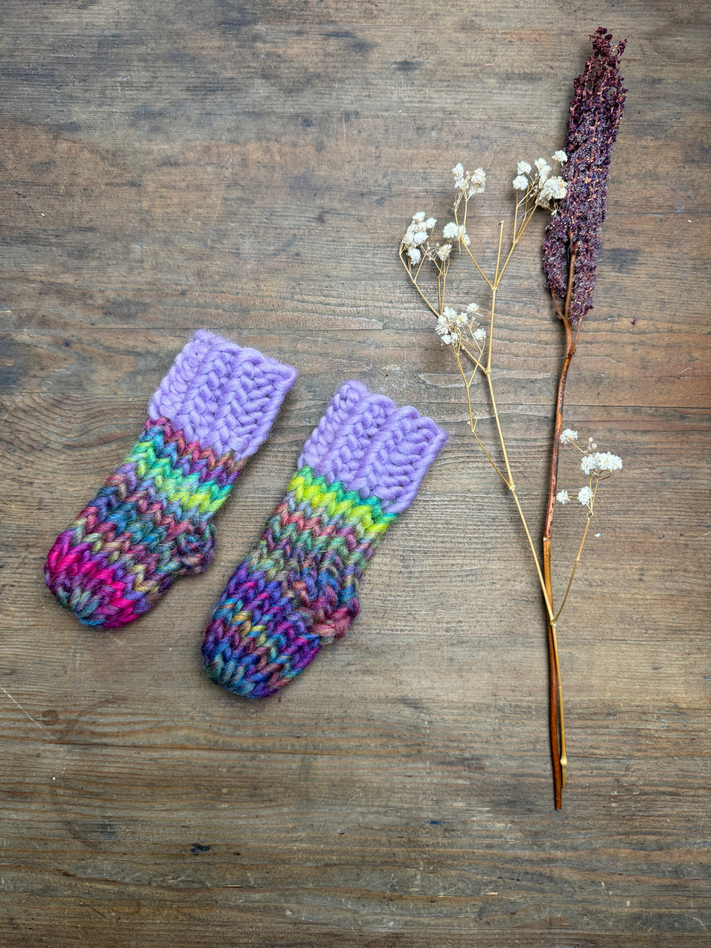 Newborn knitted socks in lilac and rainbow