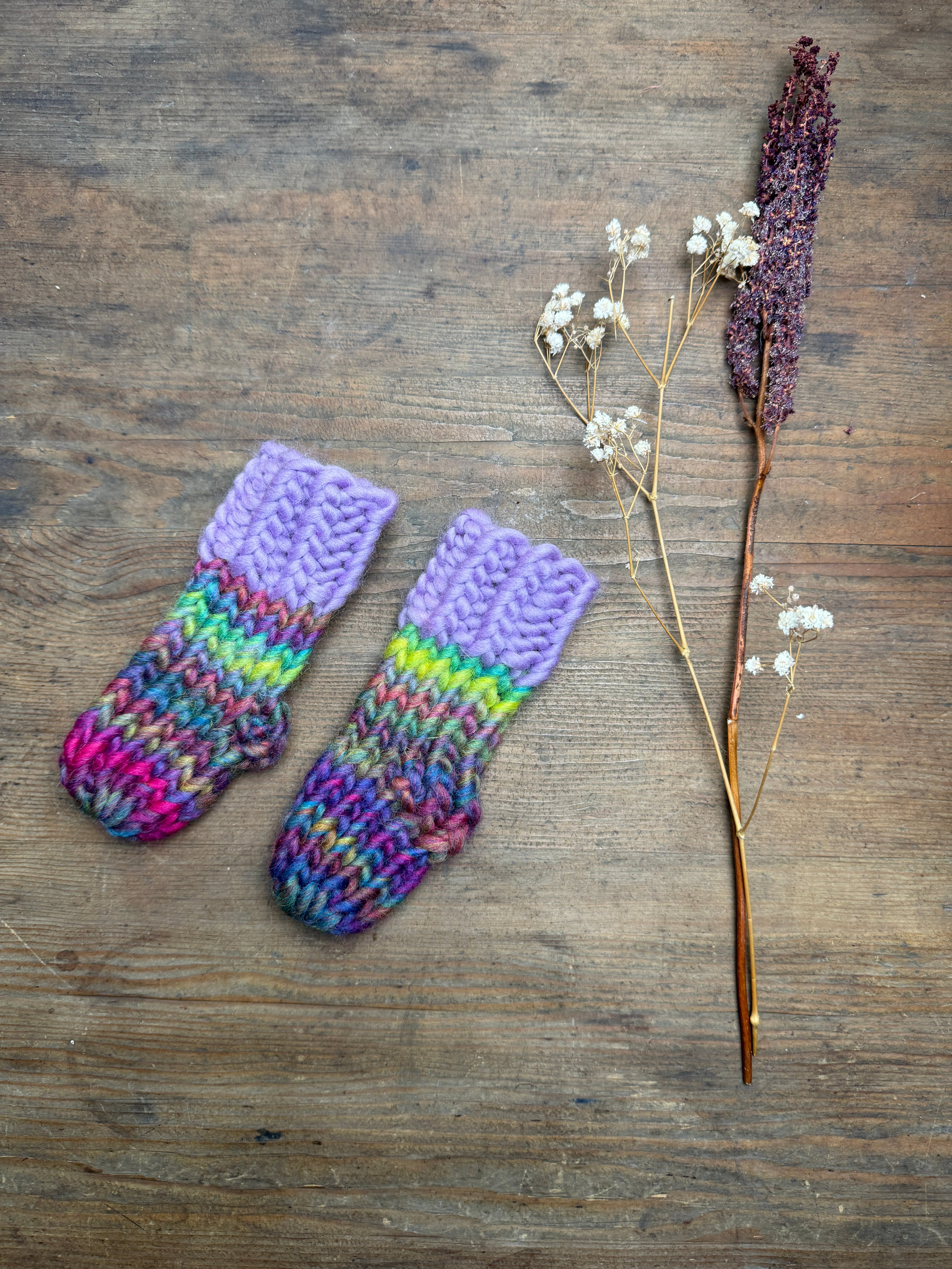 Newborn knitted socks in lilac and rainbow