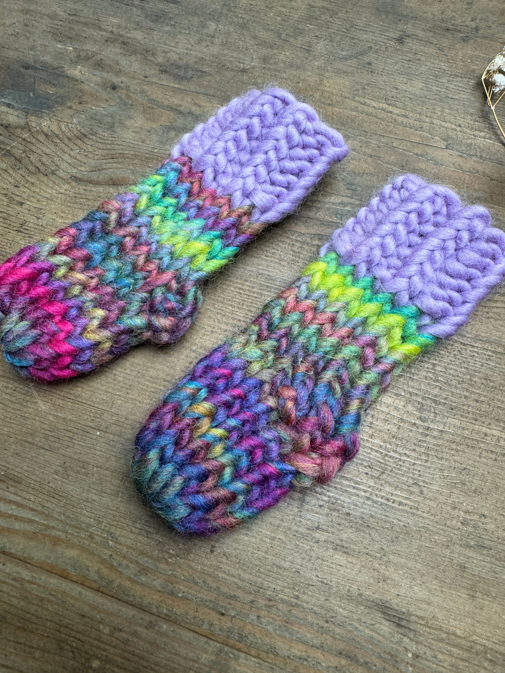 Newborn knitted socks in lilac and rainbow
