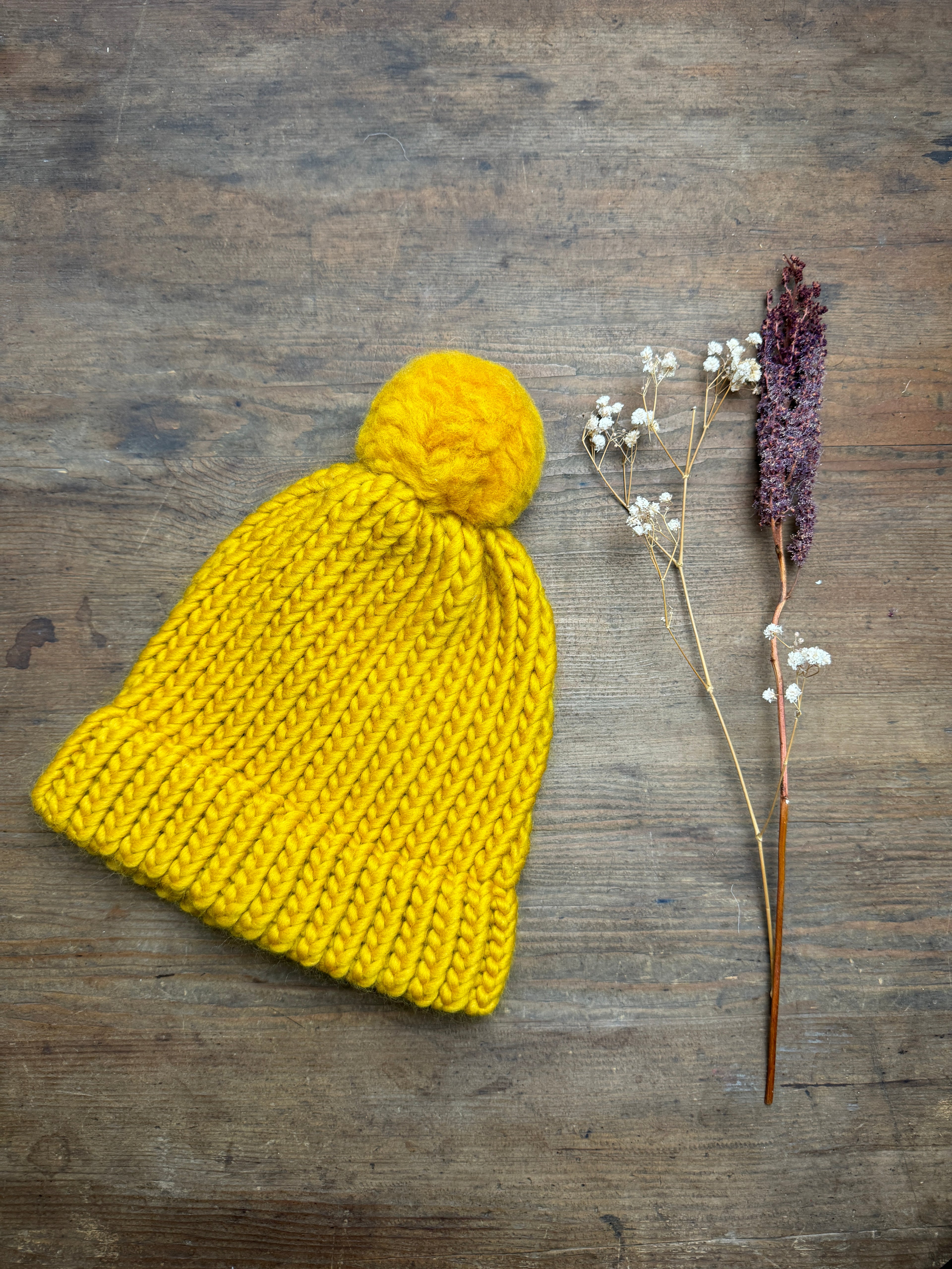 Adult knitted hat with pom pom in mustard
