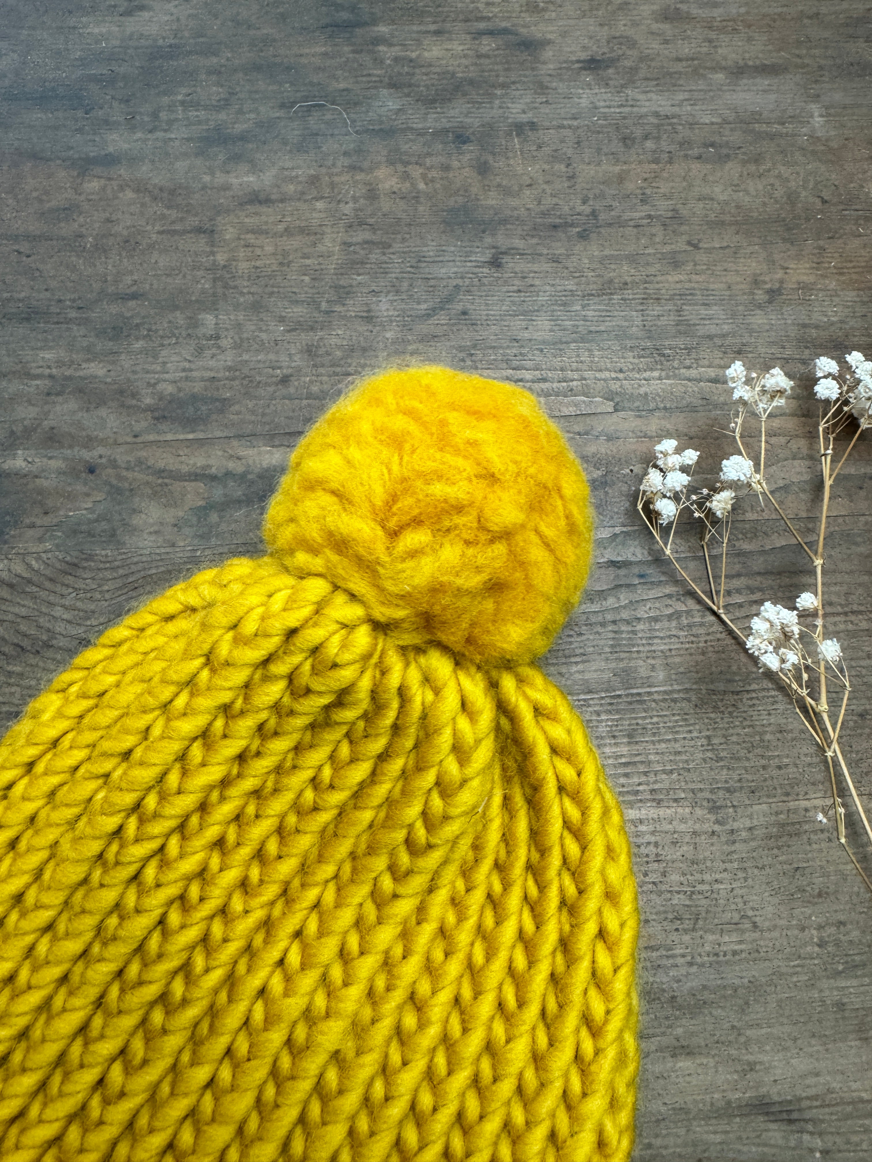 Adult knitted hat with pom pom in mustard