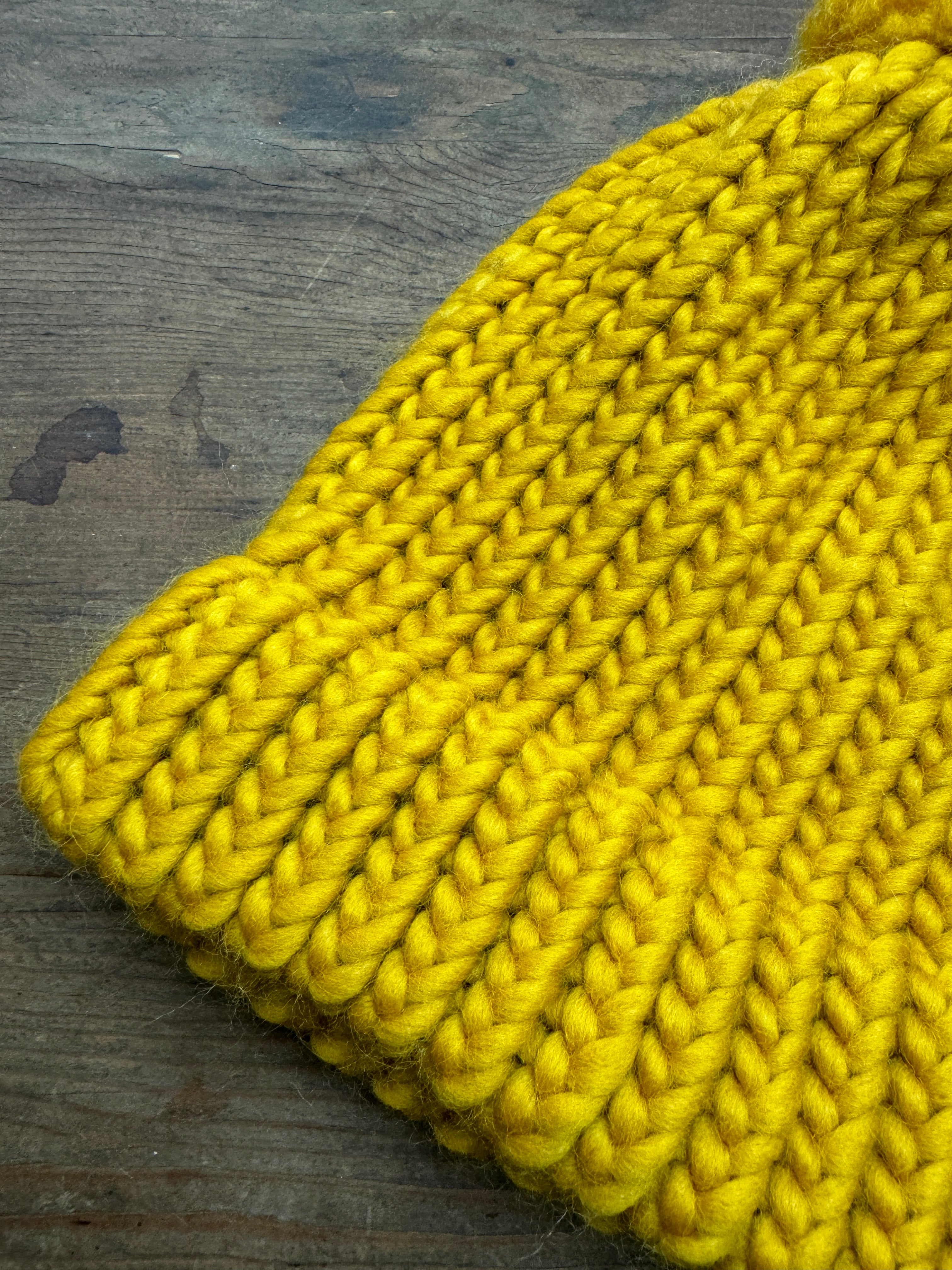Adult knitted hat with pom pom in mustard