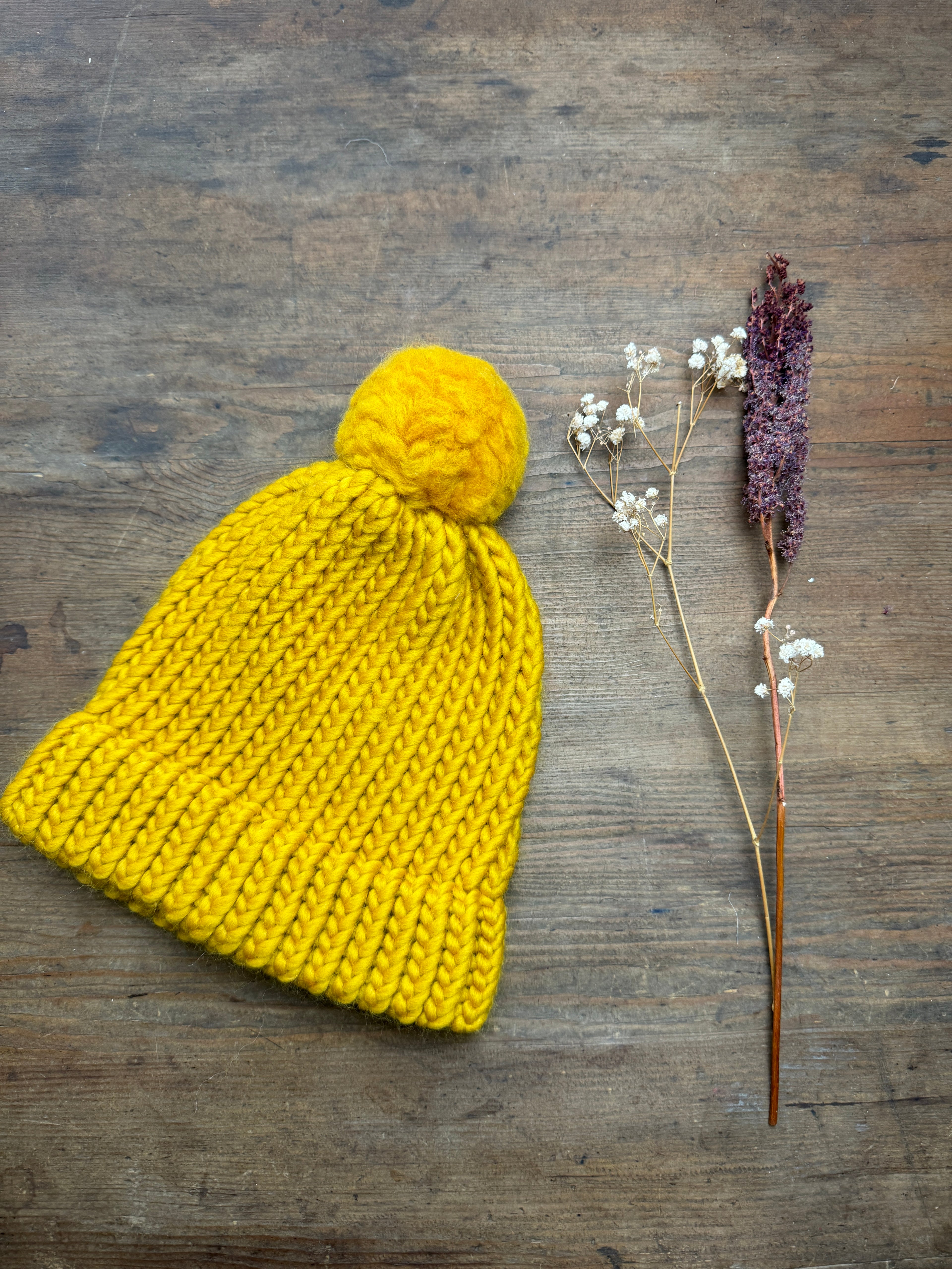 Adult knitted hat with pom pom in mustard