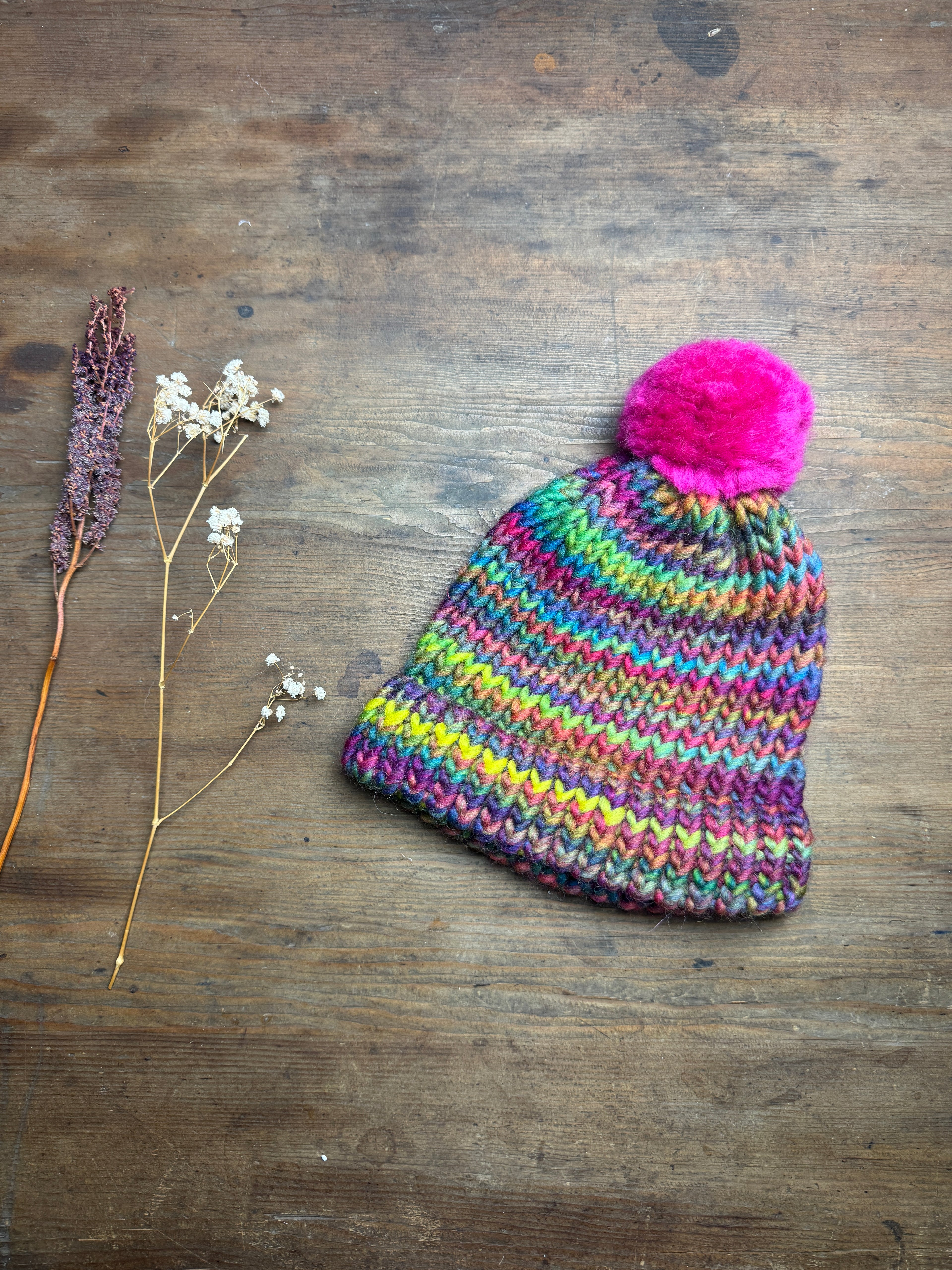 Adult knitted rainbow hat with pom pom